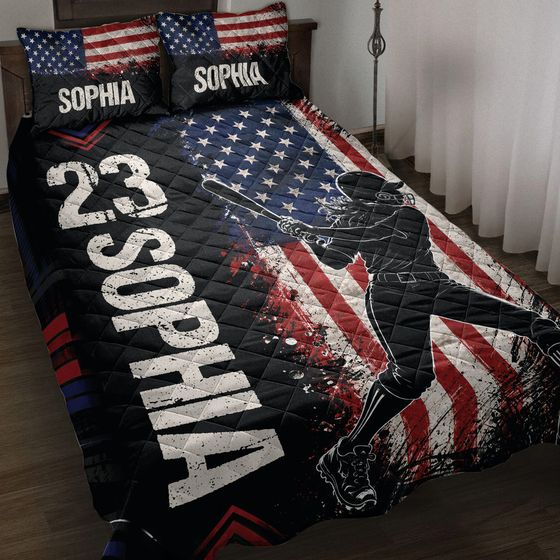 Softball quilt blanket displayed on a bed with patriotic stars, stripes, and batter artwork