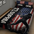 Close bedroom view of a softball quilt blanket with batter artwork, stars, stripes, and bold colors