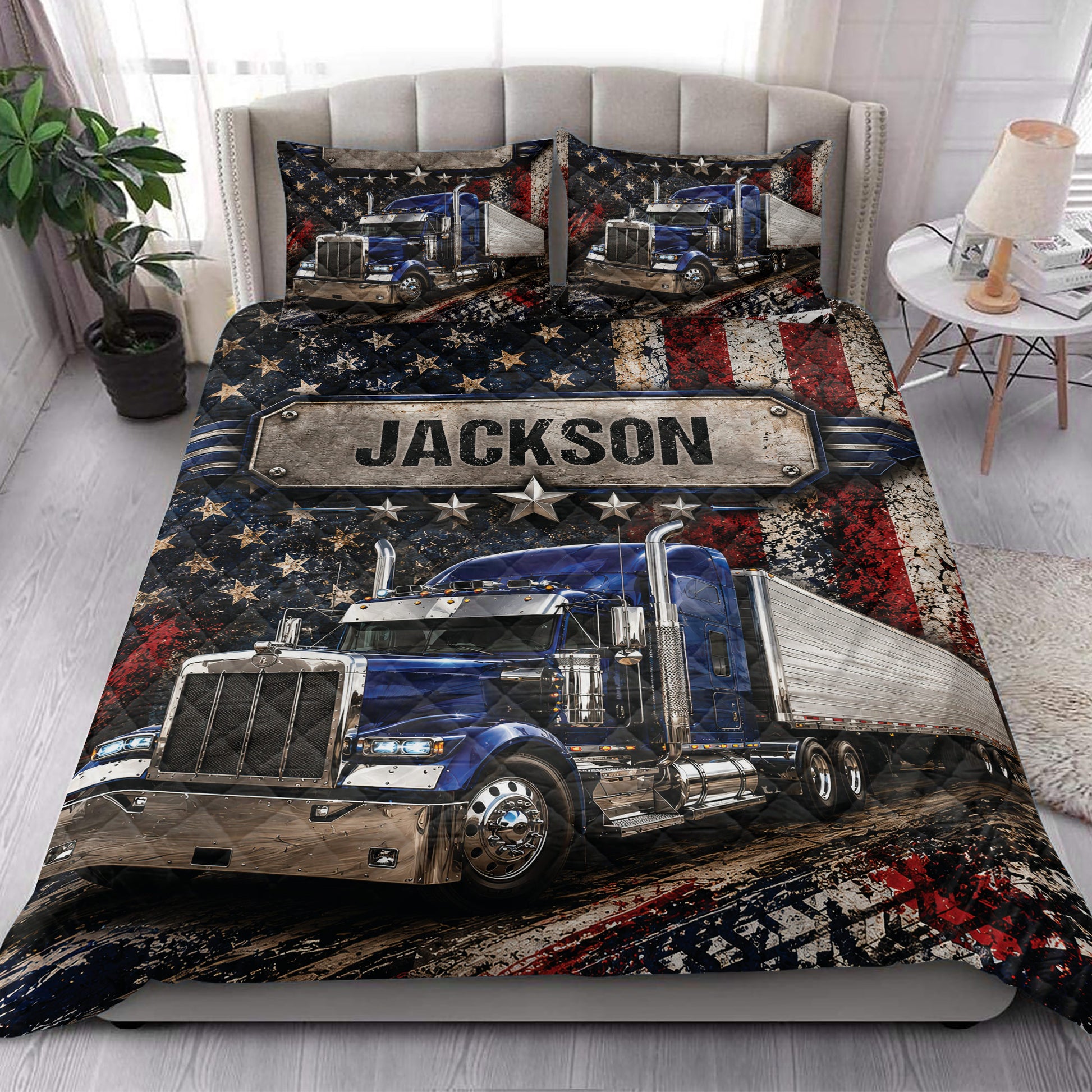 Trucker quilt blanket styled on a bedroom bed with blue semi-truck artwork and star-spangled decor