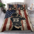Patriotic baseball quilt blanket styled on a bedroom bed with batter silhouette artwork