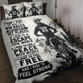 Motocross quilt blanket displayed on a bed with dirt bike rider, mountain scenery, and bold black and white artwork