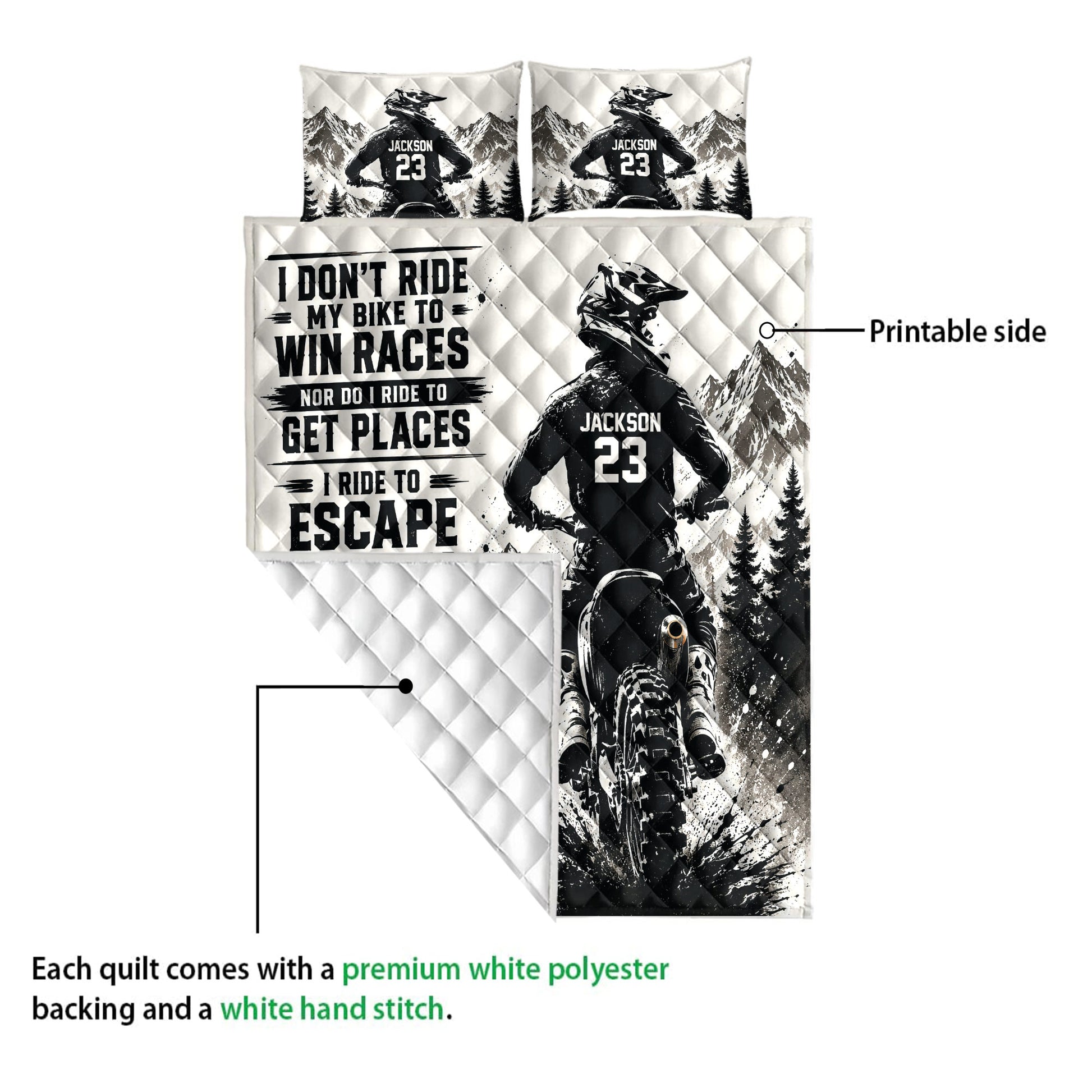 Motocross quilt blanket detail showing printed dirt bike rider artwork, mountain scene, and quilted backing