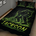 Close bedroom view of a black hockey quilt featuring neon green skaters, sticks, and puck artwork