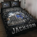 Trucker quilt blanket displayed on a bed with blue semi-truck artwork in a dramatic black and blue design