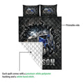 Trucker quilt blanket with blue semi-truck artwork shown with a folded corner and white backing
