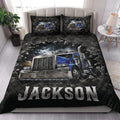 Trucker quilt bedding styled on a bed with bold blue semi-truck artwork and dark bedroom decor