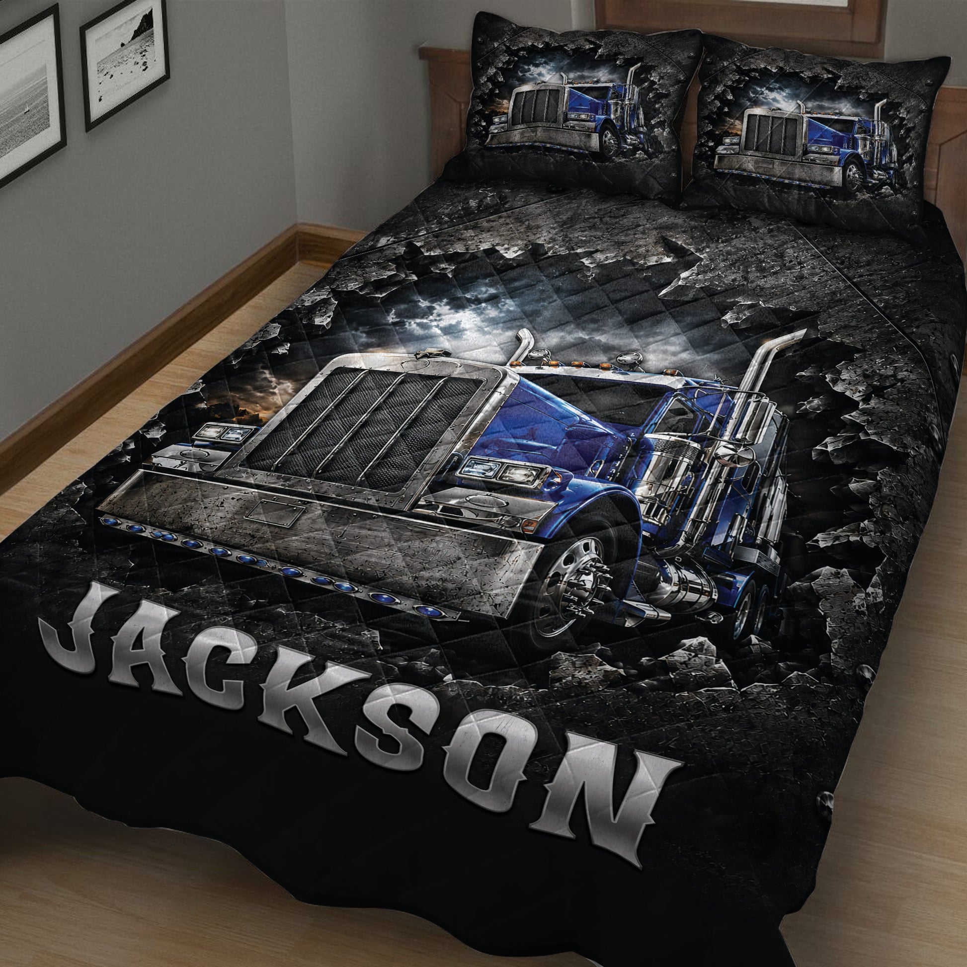 Close view of a trucker quilt blanket featuring a detailed blue semi-truck against a stormy background