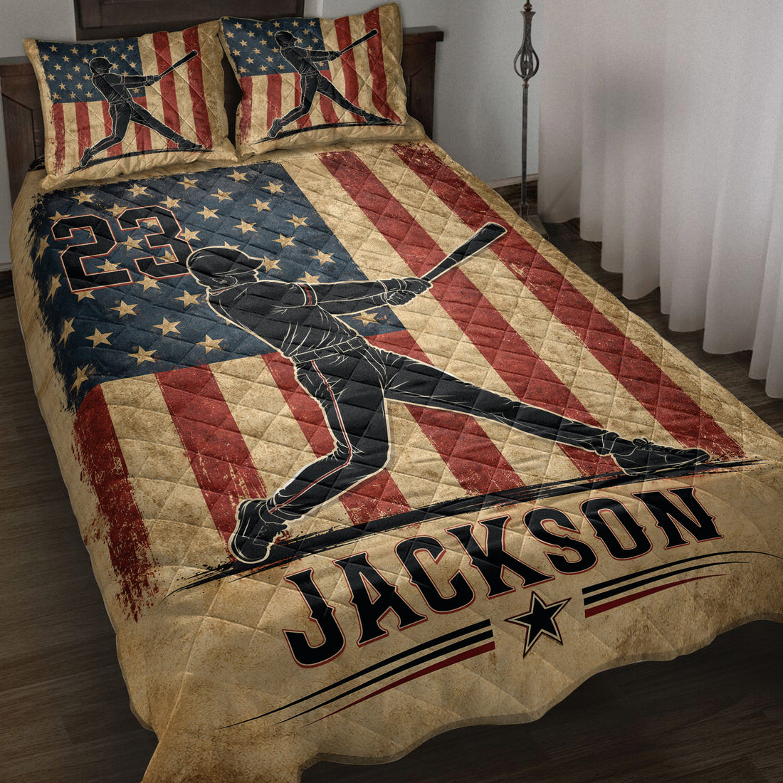 Patriotic baseball quilt blanket displayed on a bed with batter silhouettes, stars, and red white and blue stripes