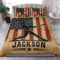 Patriotic baseball quilt styled on a bedroom bed with batter artwork and star-spangled stripes