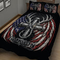 Close view of a black hunting quilt blanket with silver deer antlers and red, white, and blue feather artwork
