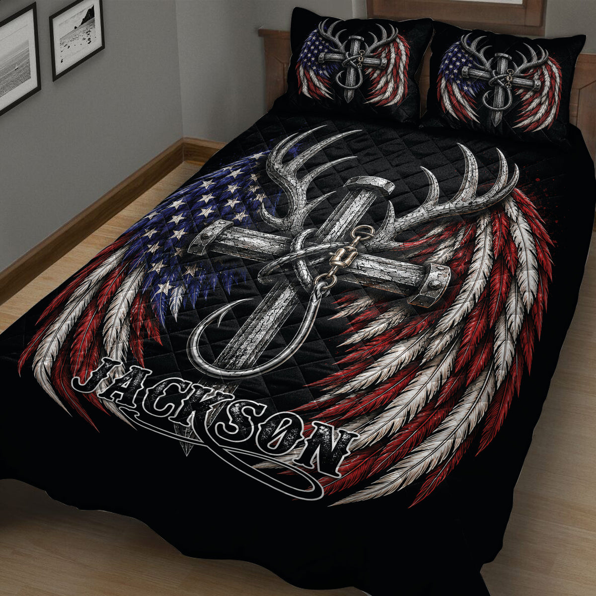 Close view of a black hunting quilt blanket with silver deer antlers and red, white, and blue feather artwork