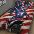 Close view of motocross quilt bedding with helmeted dirt bike rider, motorcycle details, and red, white, and blue design