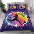 Soccer quilt bedding styled in a bright bedroom with colorful female player artwork and purple quilted borders
