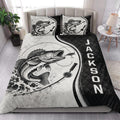 Fishing quilt blanket styled in a bright bedroom with large fish artwork and black accent panels