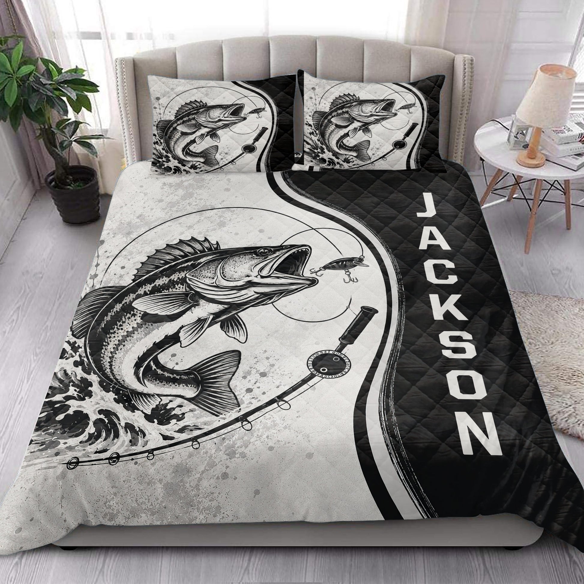 Fishing quilt blanket styled in a bright bedroom with large fish artwork and black accent panels