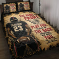 Football quilt blanket displayed on a bed with dramatic player artwork and bold black, gold, and red design