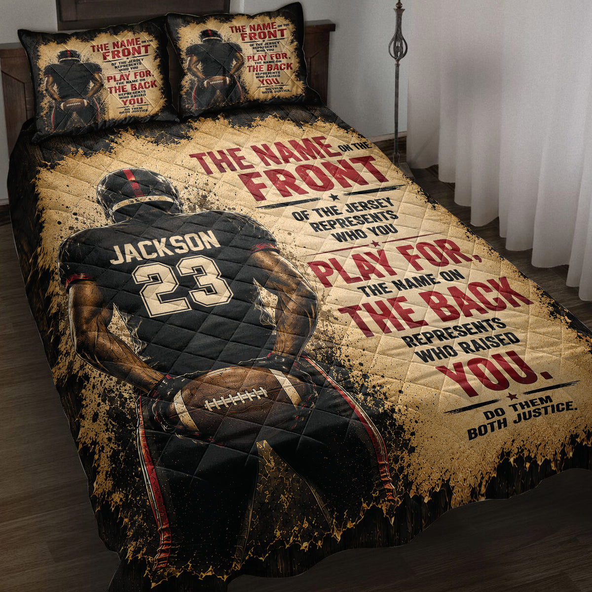 Football quilt blanket displayed on a bed with dramatic player artwork and bold black, gold, and red design