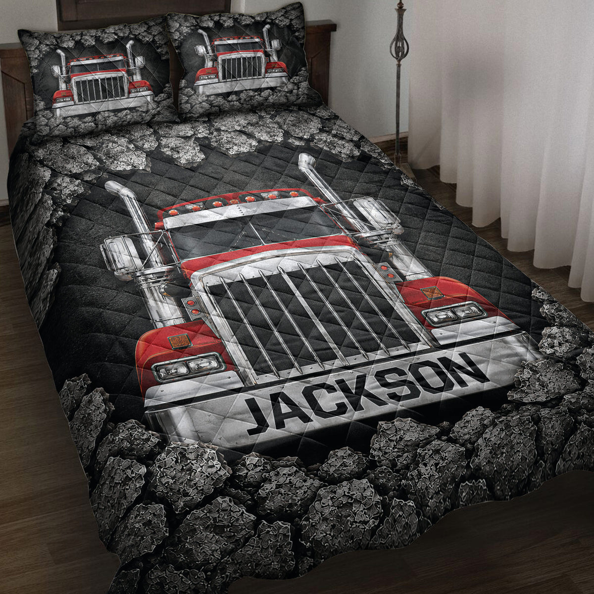Trucker quilt blanket on a bed with a red semi truck, dark rocky border, and bold black and silver artwork