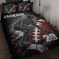 Black and red football quilt blanket displayed on a bed with football player artwork