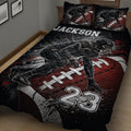 Close bedroom view of a football quilt blanket with player artwork and field markings