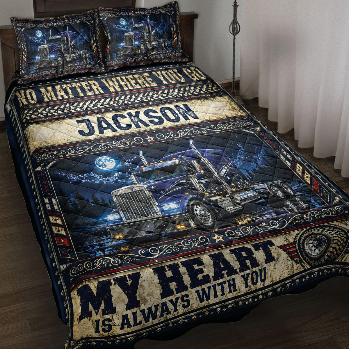 Trucker quilt blanket displayed on a bed with blue semi trucks, moonlit scenery, and bold rustic lettering