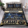 Trucker quilt styled in a bright bedroom with blue big-rig artwork and rustic navy, gold, and red accents