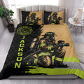 Firefighter quilt blanket styled on a bedroom bed with bold black, gold, and neon green artwork