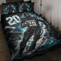 Black and teal football quilt blanket displayed on a bed with player artwork and matching sports-themed pillows