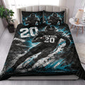 Football player quilt blanket styled on a bedroom bed with bold black, white, and teal sports artwork