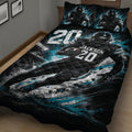 Close bedroom view of a football quilt blanket featuring a running player and dramatic stadium artwork