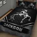 Black wrestling quilt displayed on a bed with dynamic grappling artwork and geometric sports pattern