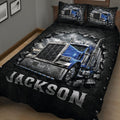 Close-up of a trucker quilt blanket featuring a detailed blue big rig against a black automotive-inspired background