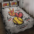 Softball quilt blanket displayed on a bed with red and yellow softball artwork, hearts, and sports-themed lettering