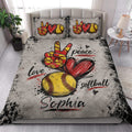 Softball quilt blanket styled in a bright bedroom with red hearts, yellow softballs, and distressed sports artwork