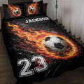 Soccer quilt blanket with a flaming soccer ball design in black, orange, red, and white