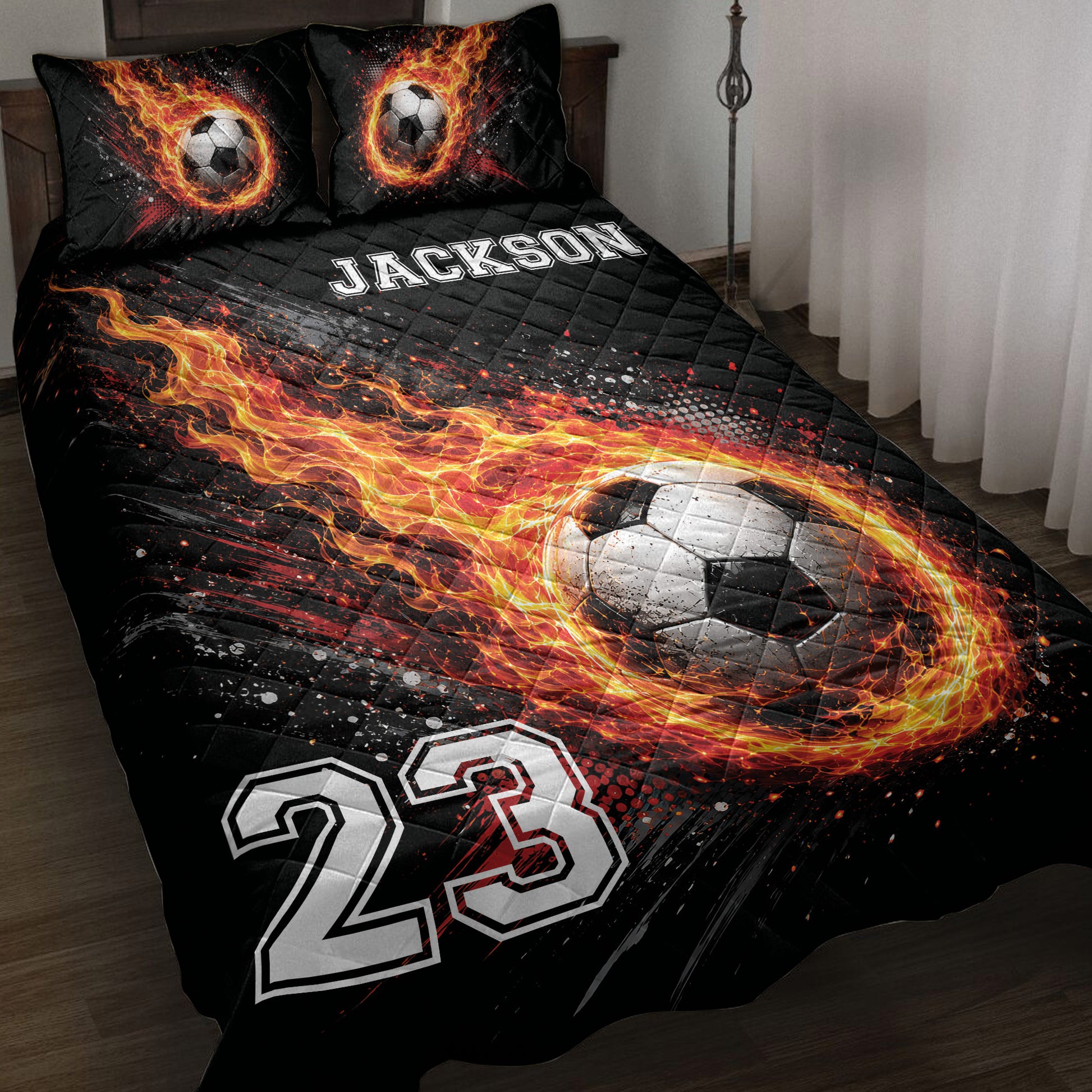 Soccer quilt blanket with a flaming soccer ball design in black, orange, red, and white