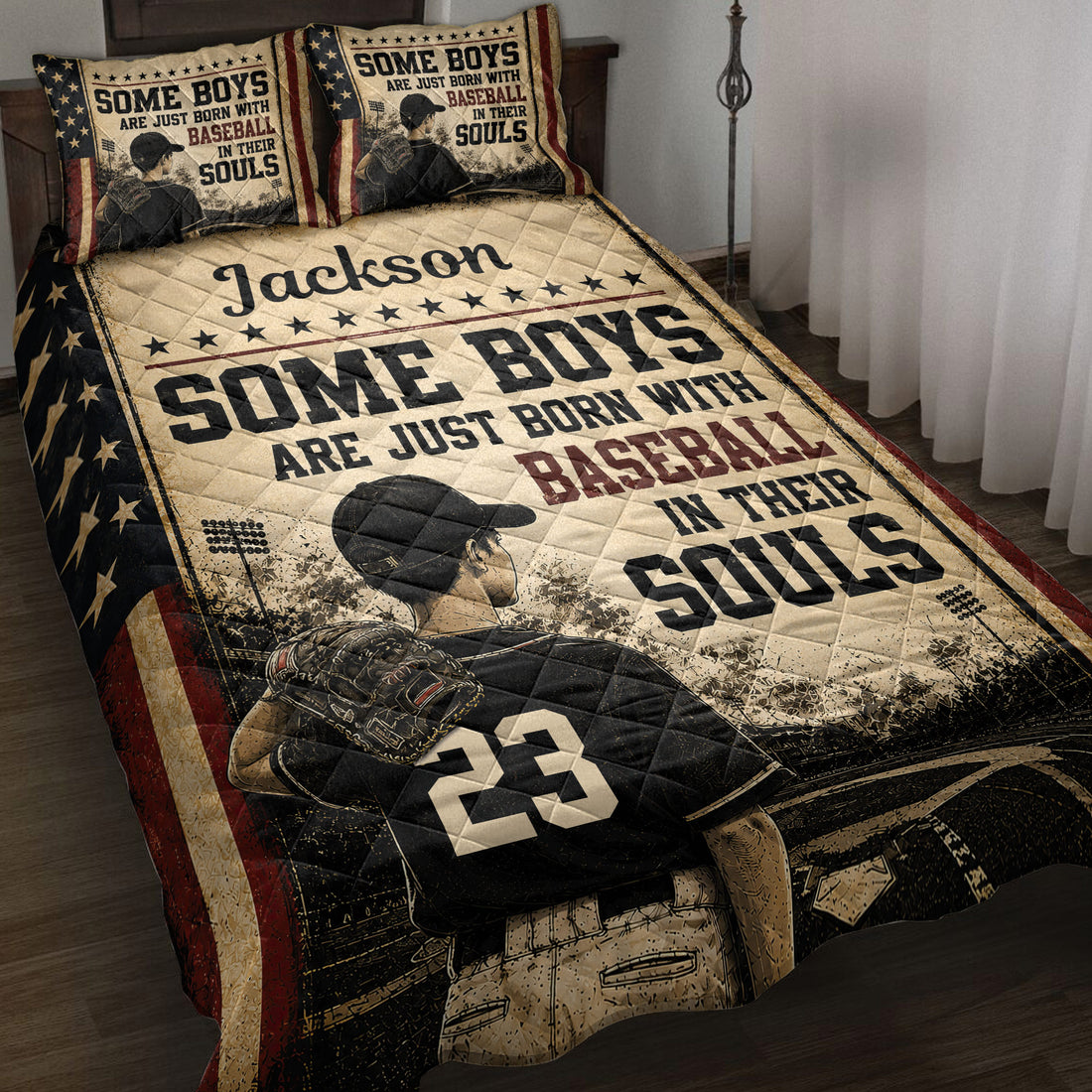 Patriotic baseball quilt blanket displayed on a bed with a ballplayer, glove, stars, and vintage sports artwork