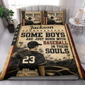 Baseball quilt blanket styled in a bedroom with patriotic colors, ballplayer artwork, stars, and vintage sports details
