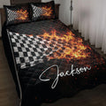 Racing quilt blanket with flaming black and white checkered flags displayed on a bedroom bed