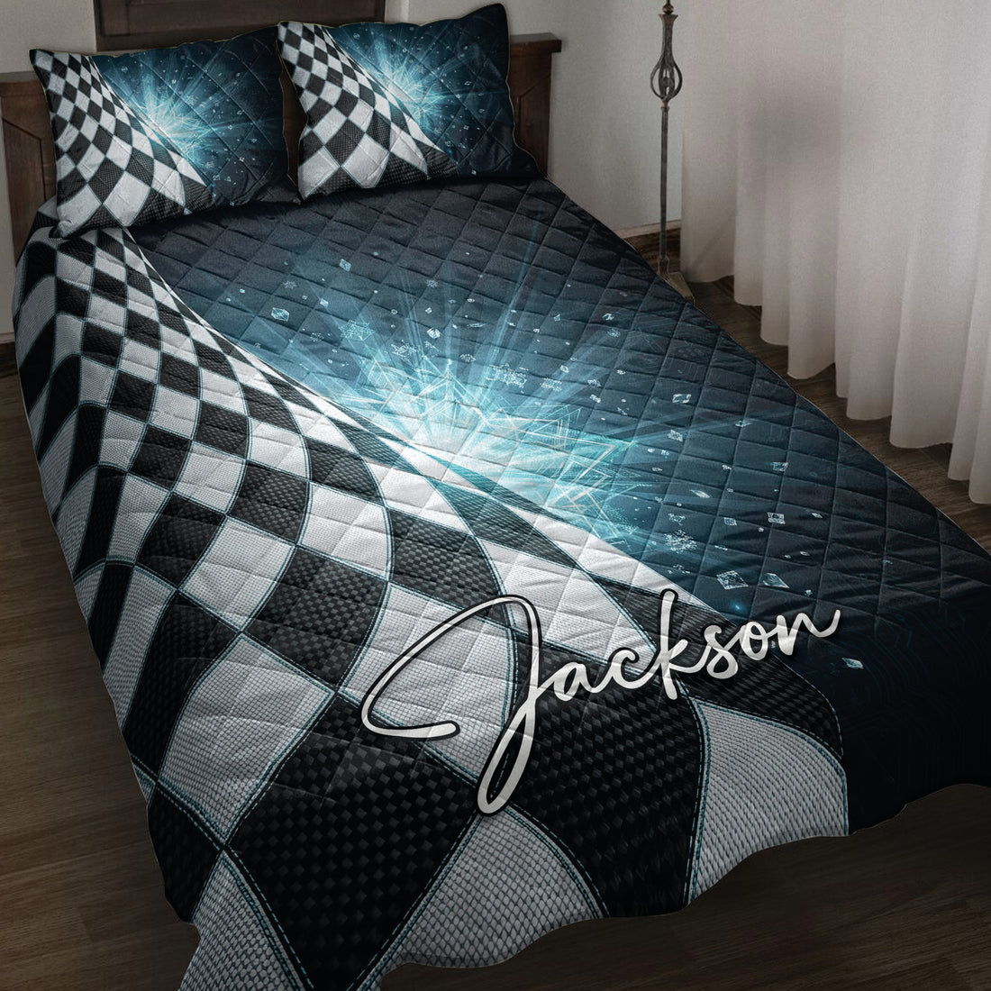 Racing quilt blanket displayed on a bed with black and white checkered flag artwork and blue geometric accents
