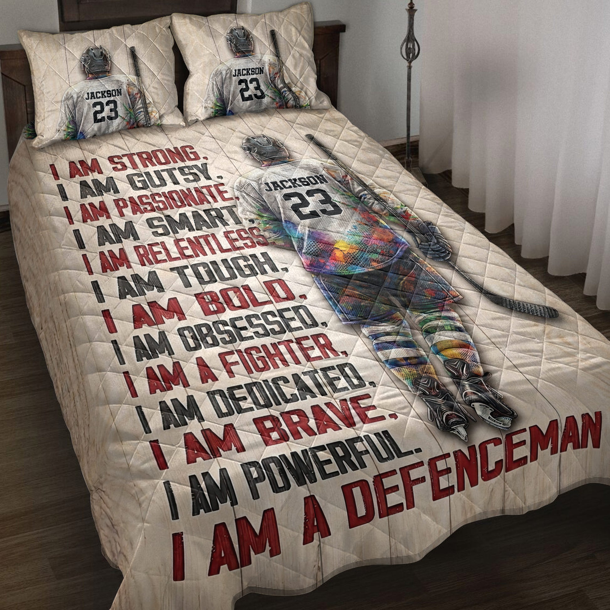 Hockey quilt bedding set displayed on a bed with colorful hockey player artwork and motivational sports typography