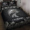 Black fishing quilt blanket displayed on a bed with a large silver bass and rocky shoreline artwork