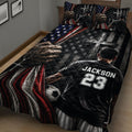 Close view of soccer quilt blanket featuring a player, soccer ball, American flag colors, and cross artwork