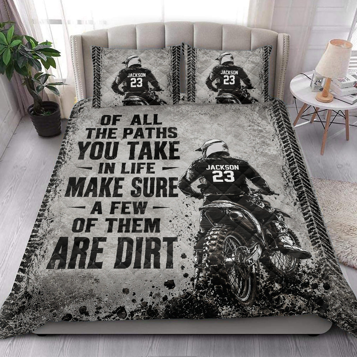 Motocross quilt bedding styled in a bright bedroom with dirt bike rider artwork and bold black typography