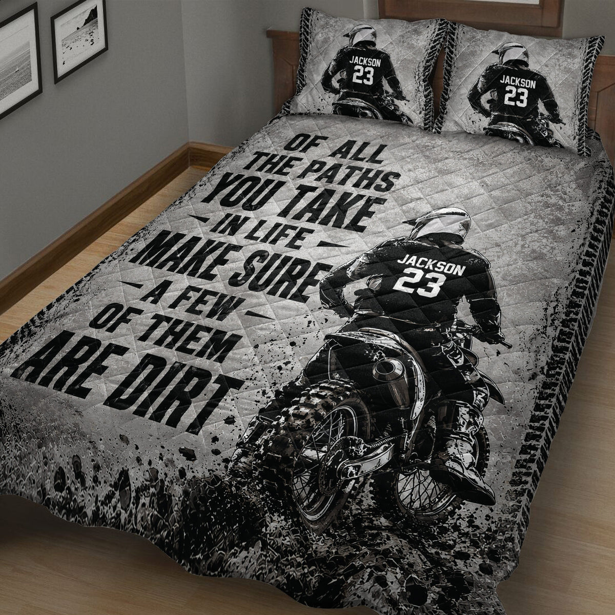 Close view of a motocross quilt blanket featuring an off-road rider, dirt bike, tire tracks, and grayscale artwork