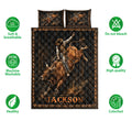 Rodeo quilt bedding set displayed with bull riding artwork, dark wood textures, and western-inspired colors
