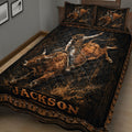 Close view of rodeo quilt blanket artwork with a cowboy riding a bucking bull in a dark western scene