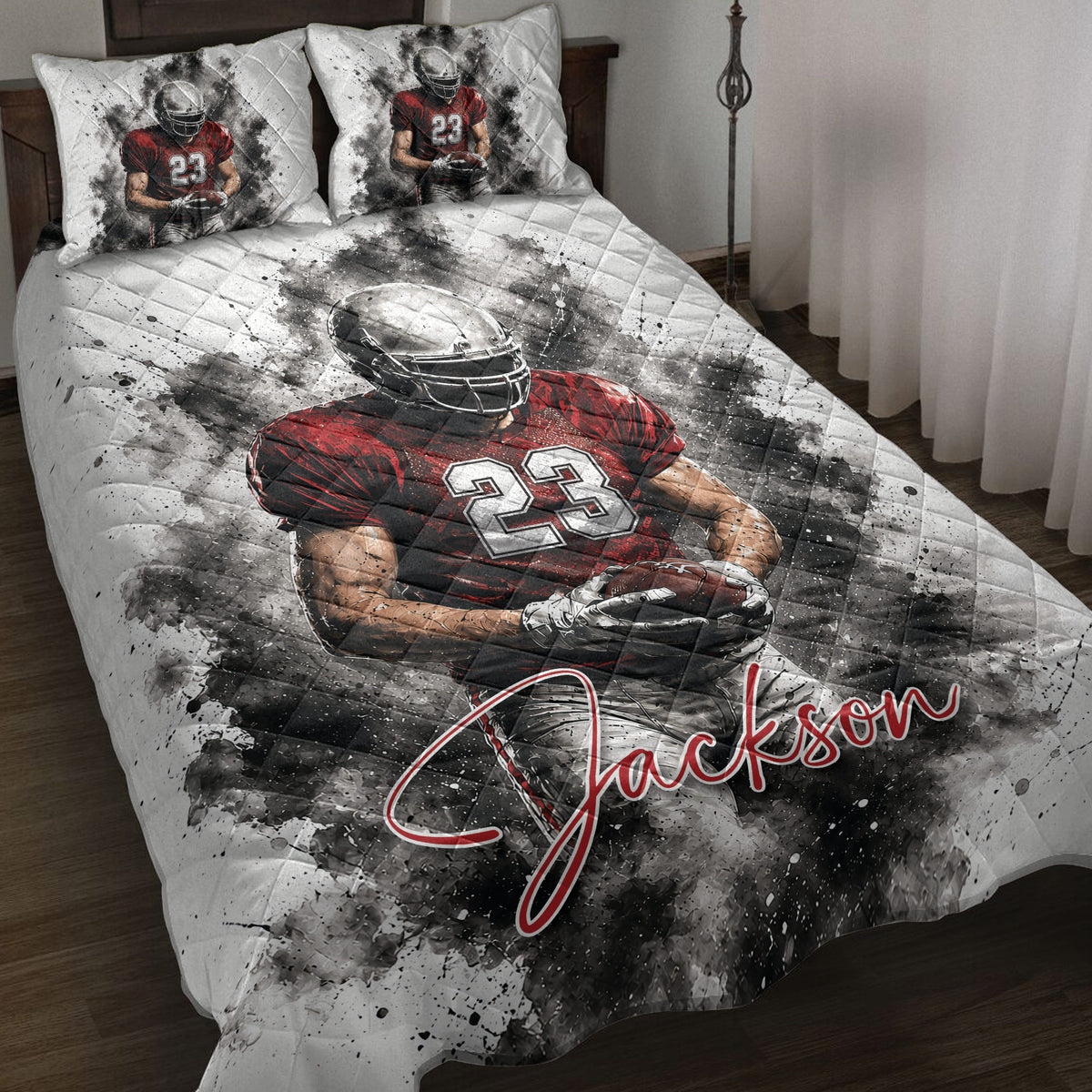 Football quilt blanket displayed on a bed with red and black player artwork and coordinated pillow designs