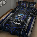Close-up of a trucker quilt blanket with blue semi-truck artwork, stars, and geometric black accents