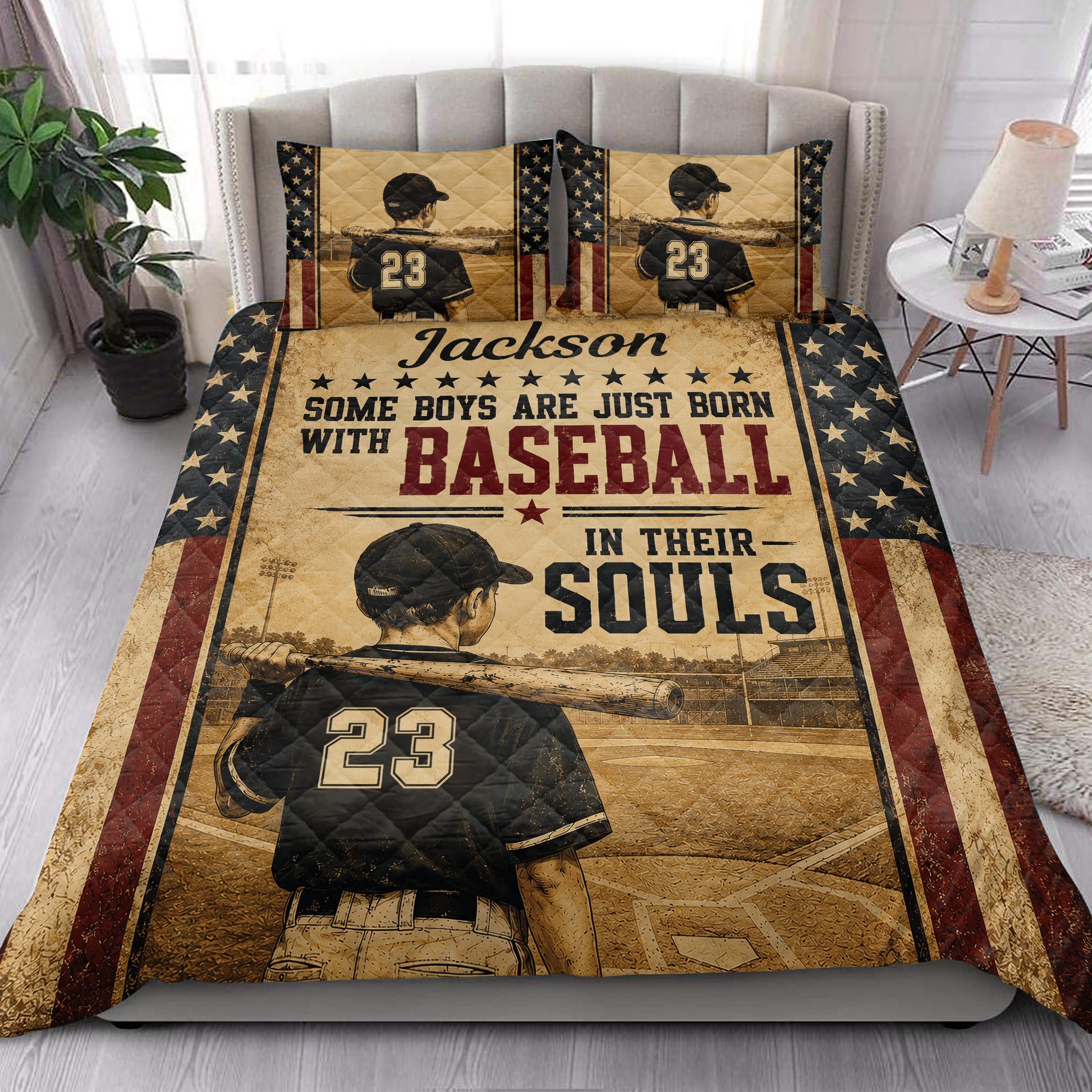 Baseball quilt blanket styled on a bed with vintage player artwork and patriotic star borders